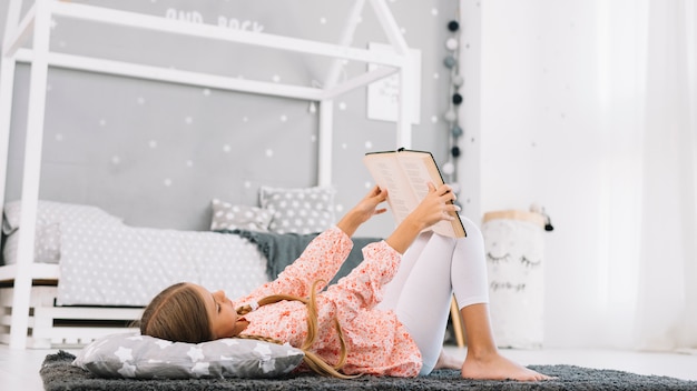 Adorável menina lendo um livro