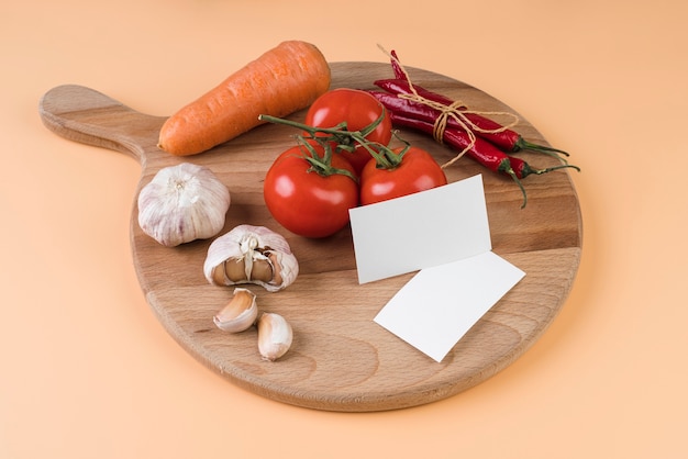 Foto grátis alto ângulo de tábua com tomate e alho