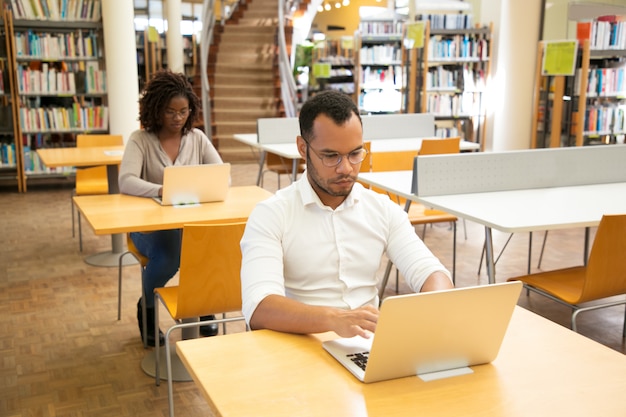 Alunos adultos focados fazendo testes on-line