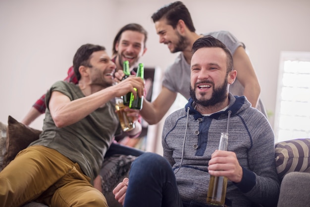 Amigos bebendo cerveja e assistindo jogo de futebol