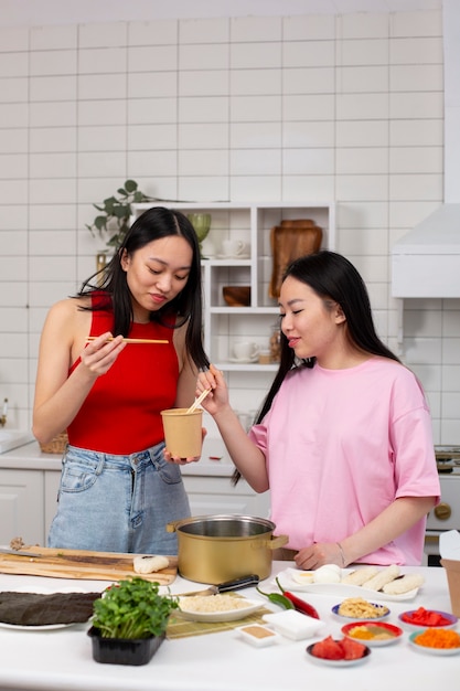 Amigos cozinhando comida japonesa juntos