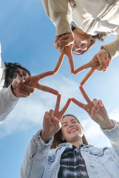 Amigos, formando uma estrela com os dedos