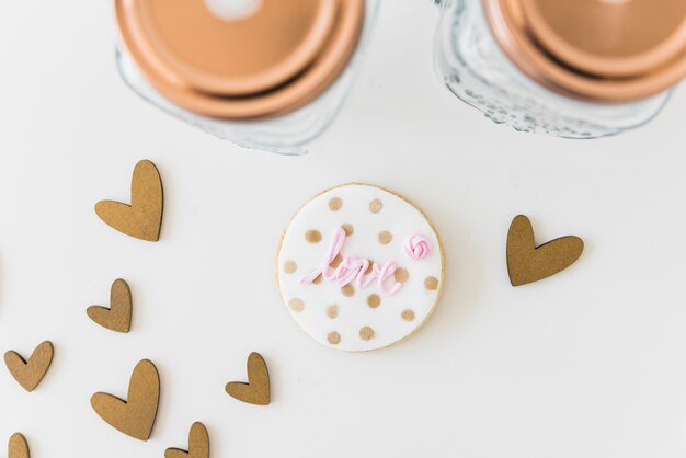 Amo circular biscoito com formas de coração e jar em pano de fundo branco