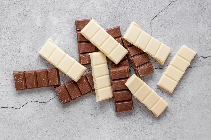 Foto grátis arranjo de chocolate doce plana