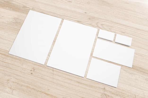 Artigos de papelaria de papel em branco na mesa de madeira