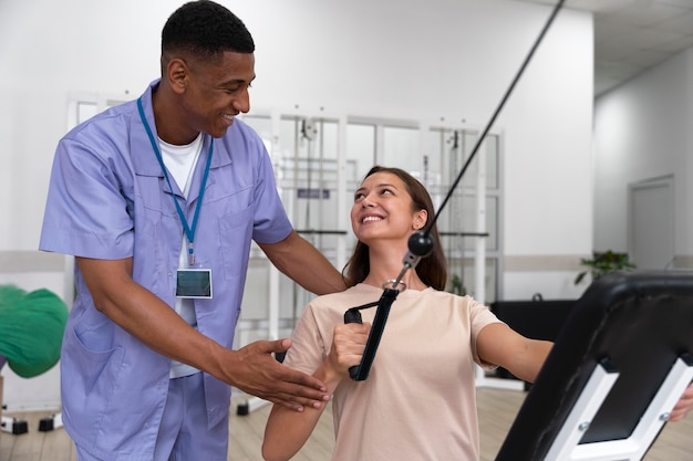 Assistente médico ajudando paciente com exercícios de fisioterapia