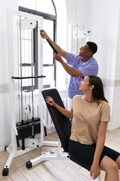 Assistente médico ajudando paciente com exercícios de fisioterapia