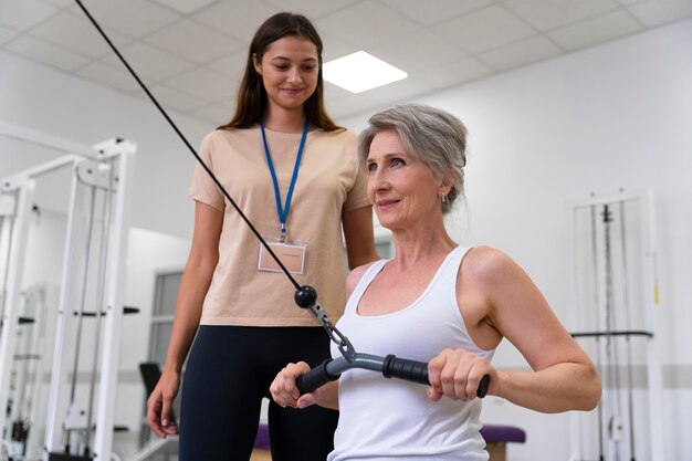 Assistente médico ajudando paciente com exercícios de fisioterapia