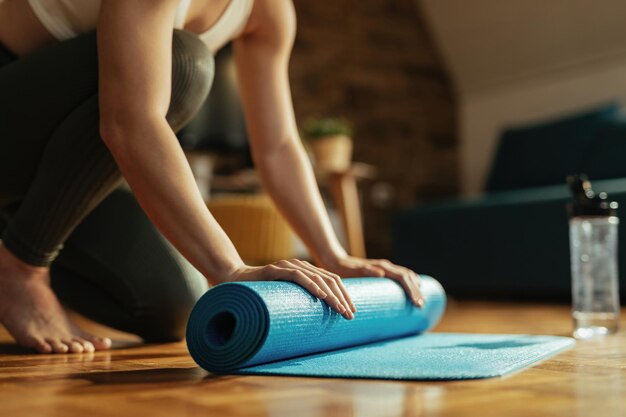 Atleta irreconhecível, desenrolando o homem do exercício enquanto se prepara para o treino em casa