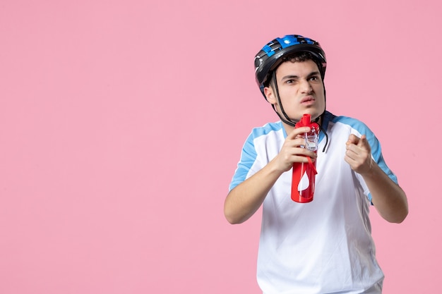 Atleta masculino de vista frontal com roupas esportivas com capacete e garrafa de água