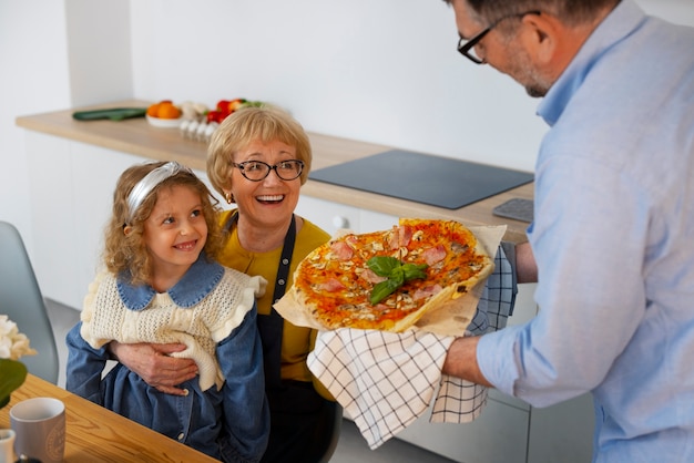 Foto grátis avós de vista lateral e menina na cozinha