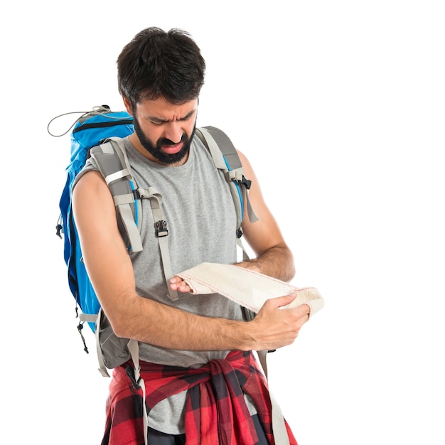 Backpacker curando um ferido sobre fundo branco