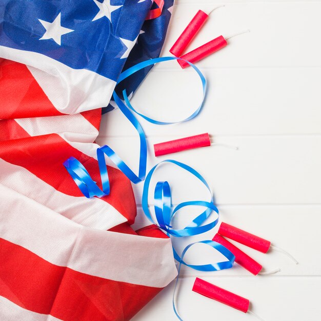 Bandeira americana franzida; fita azul e panquecas de dinamite na mesa de madeira