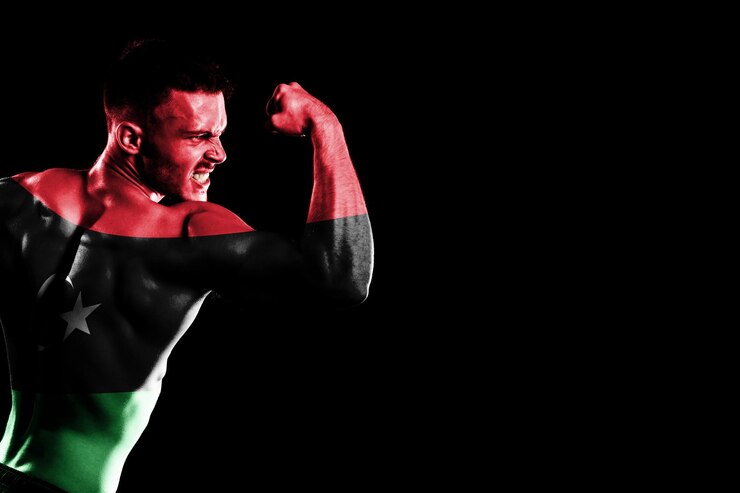 Foto grátis bandeira da líbia em fundo preto bonito jovem musculoso