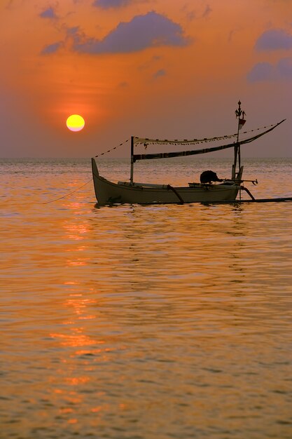 Barco de pesca no por do sol