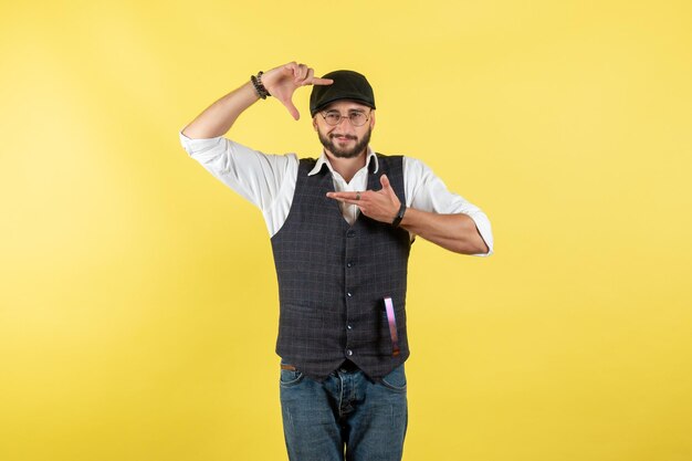 Barman masculino posando na parede amarela bebida alcoólica masculina noturna bar