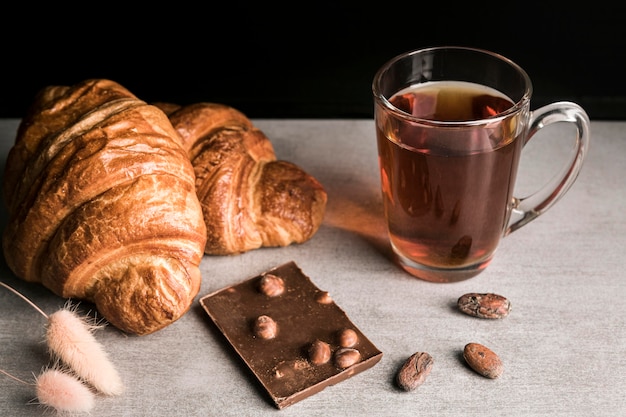 Barra de chocolate e croissants de alto ângulo com bebidas