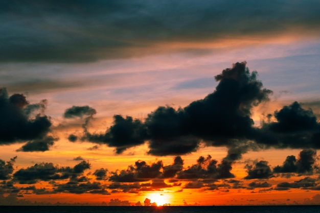 Beautiful motion blur por do sol ou nascer do sol de longa exposição com nuvens dramáticas do céu sobre o mar calmo na ilha tropical de phuket.