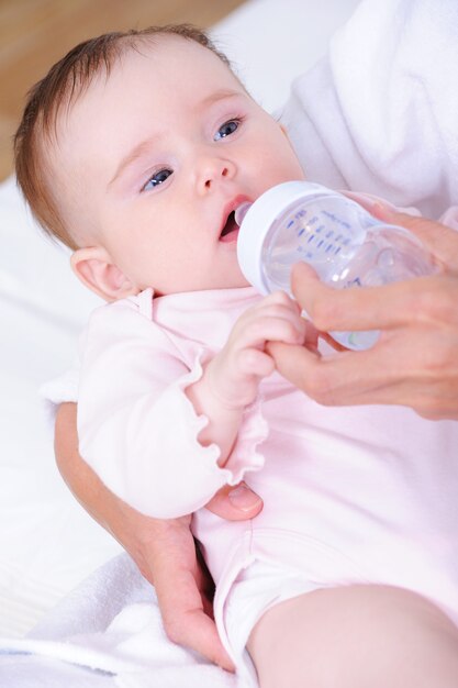 Bebê com mamadeira de plástico