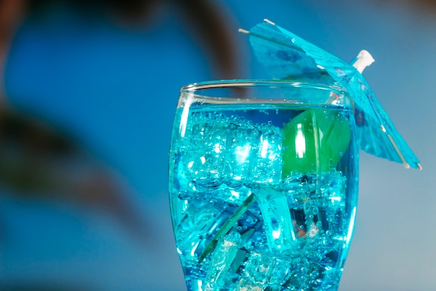 Bebida azul com hortelã em vidro decorado guarda-chuva
