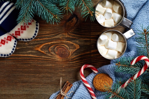 Bebida de Natal. Caneca de café quente com marshmallow, pirulito vermelho sobre o fundo de madeira. Ano Novo. Cartão de férias. Estilo rústico. Vista superior e copie o espaço.. Ano novo 2018