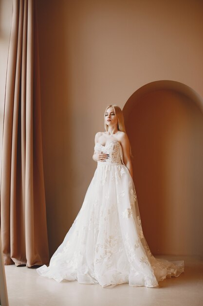 Bela modelo com noiva maquiagem e penteado em vestido de renda de casamento.