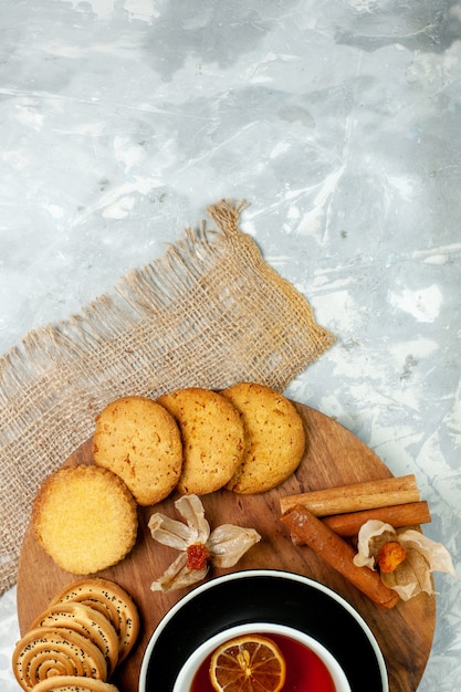 Biscoitos de açúcar com uma xícara de chá na mesa branca