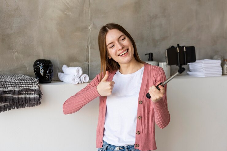 Foto grátis blogger gravando-se mostrando a decoração da casa e o polegar para cima