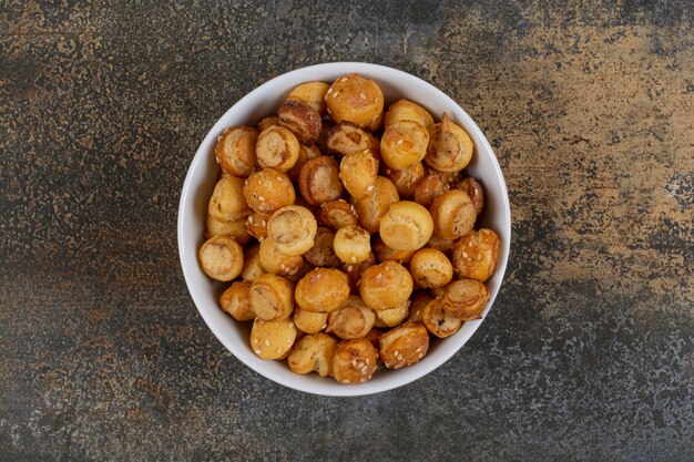 Bolachas saborosas salgadas em uma tigela branca.