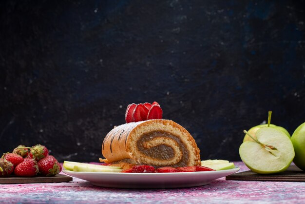 Foto grátis bolo de rolo de vista frontal com frutas dentro de um prato branco em um bolo escuro