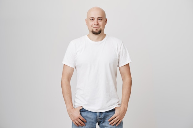 Bonito homem careca de meia-idade com barba e camiseta branca casual