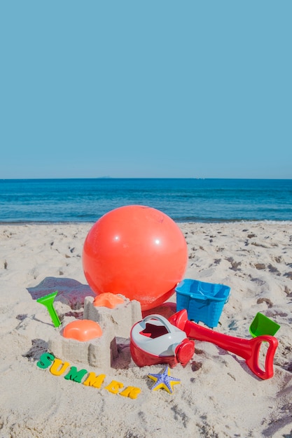 Brinquedos e bola de vento na areia