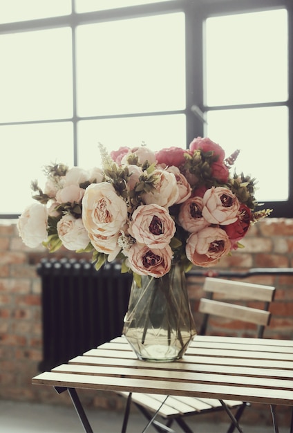 Buquê de rosas lindas na mesa de madeira