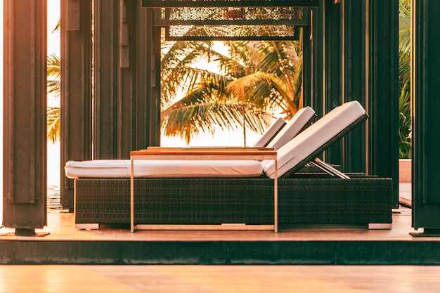 Foto grátis cadeira vazia em torno da piscina no hotel e resort para viagens de lazer