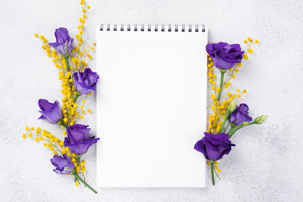 Caderno com flores desabrochando ao lado