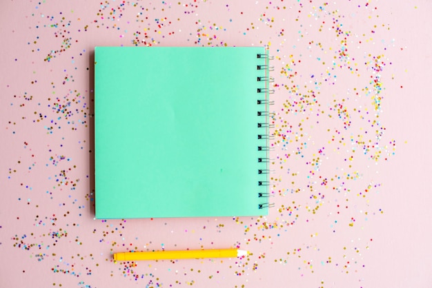 Caderno em branco e caneta com confete