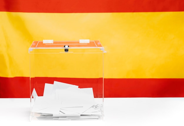 Caixa de votação transparente no fundo da bandeira espanhola