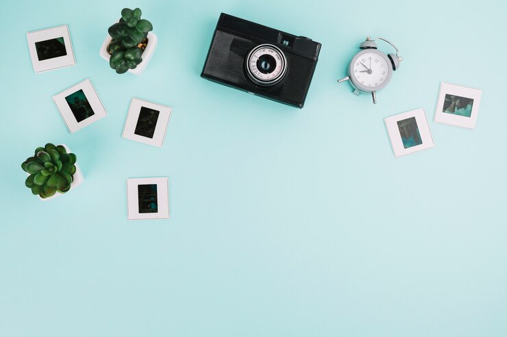 Foto grátis câmera de vista superior com negativos, relógio e plantas