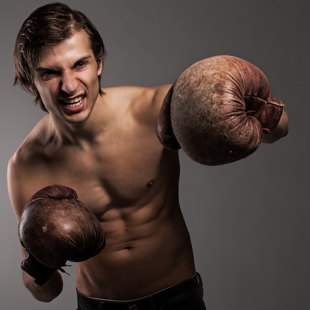 Cara agressiva em uma luvas de boxe