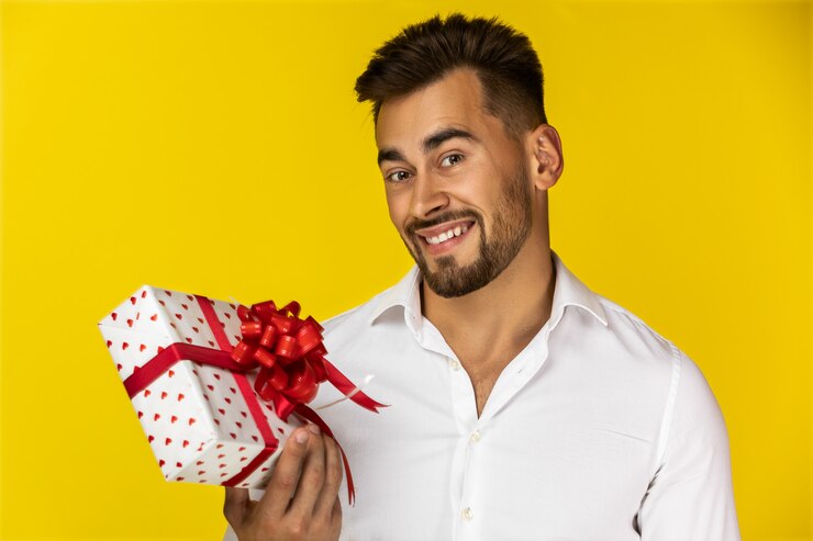 Foto grátis cara sorridente, segurando uma caixa de presente