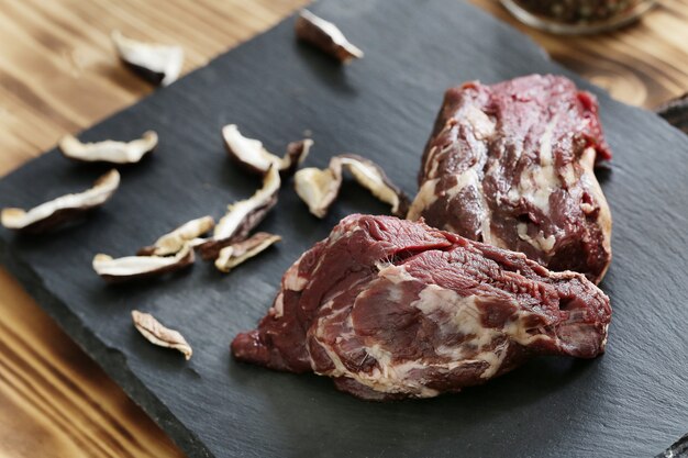 Carne crua com ingredientes para cozinhar a refeição