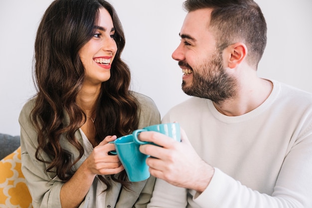 Casal alegre com canecas azuis