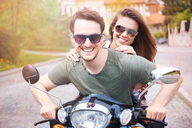 Casal andando de moto na cidade