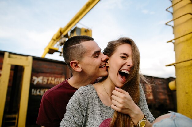 Casal apaixonado. Jovem homem divertidamente morder a orelha da namorada. História de amor.