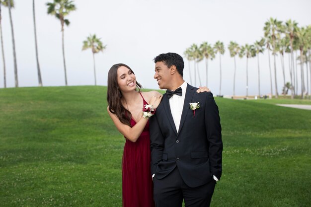 Casal com roupas de baile de formatura ao ar livre