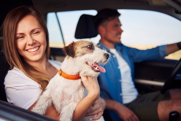 Casal de felicidade e seu cachorro viajando juntos.