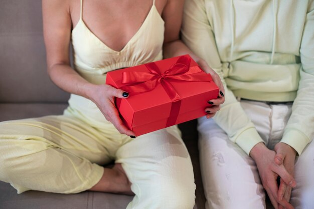 Casal em casa comemorando o dia dos namorados com caixa de presente