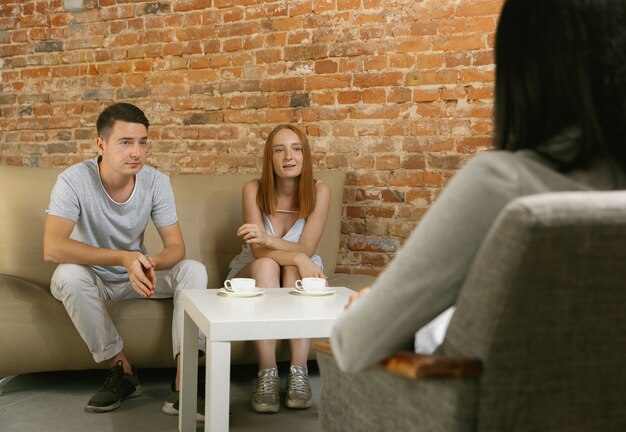 Casal em terapia ou aconselhamento matrimonial. Psicólogo, conselheiro, terapeuta ou consultor de relacionamento dando conselhos. Homem e mulher sentados em uma sessão de psicoterapia. Família, conceito de saúde mental.