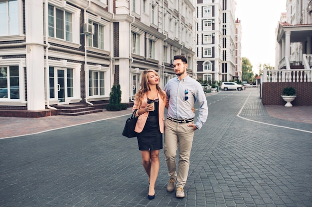 Casal feliz andando pelo bairro britânico.