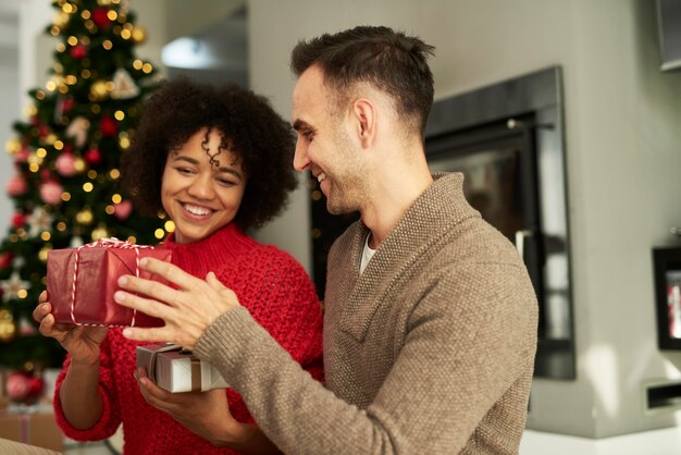 Casal feliz compartilhando os presentes de Natal